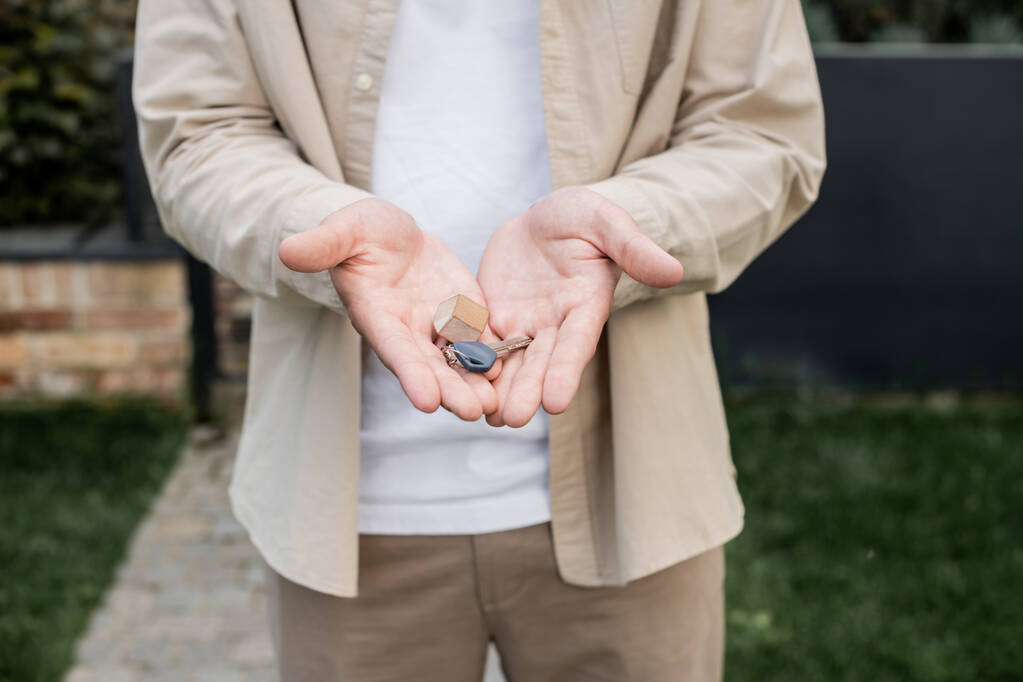 cropped view of real estate broker with key from new house in hands outdoors - Photo, Image