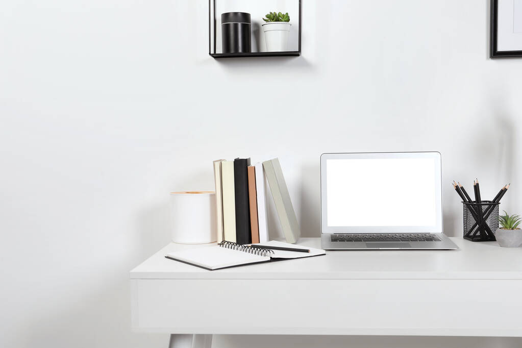 Accogliente spazio di lavoro con computer portatile e cancelleria su scrivania in legno a casa. Spazio per testo - Foto, immagini