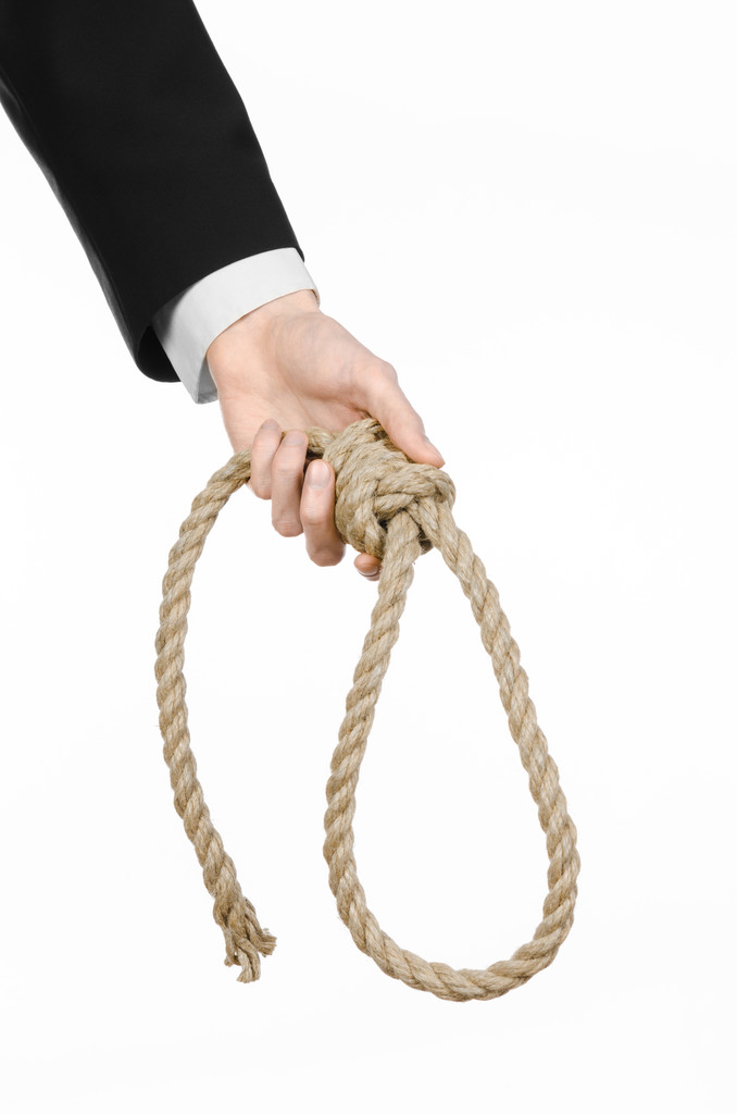 Öngyilkosság és üzleti téma: egy üzletember egy fekete kabát gazdaság egy hurok-ból kötél lógott, fehér keze elszigetelt háttér - Fotó, kép