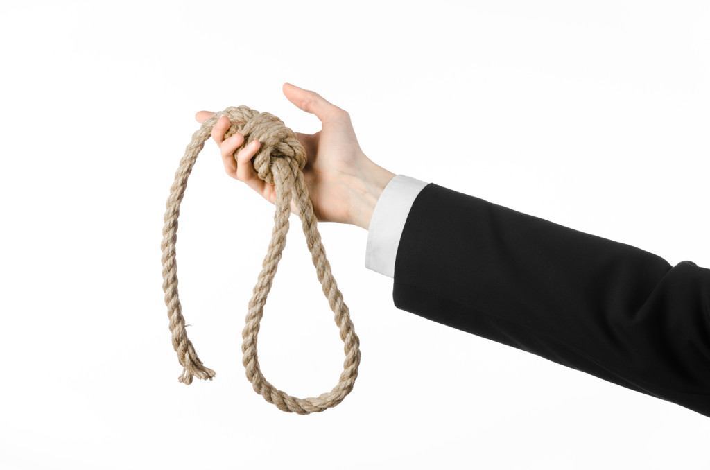 Suicide and business topic: Hand of a businessman in a black jacket holding a loop of rope for hanging on white isolated background - Photo, Image