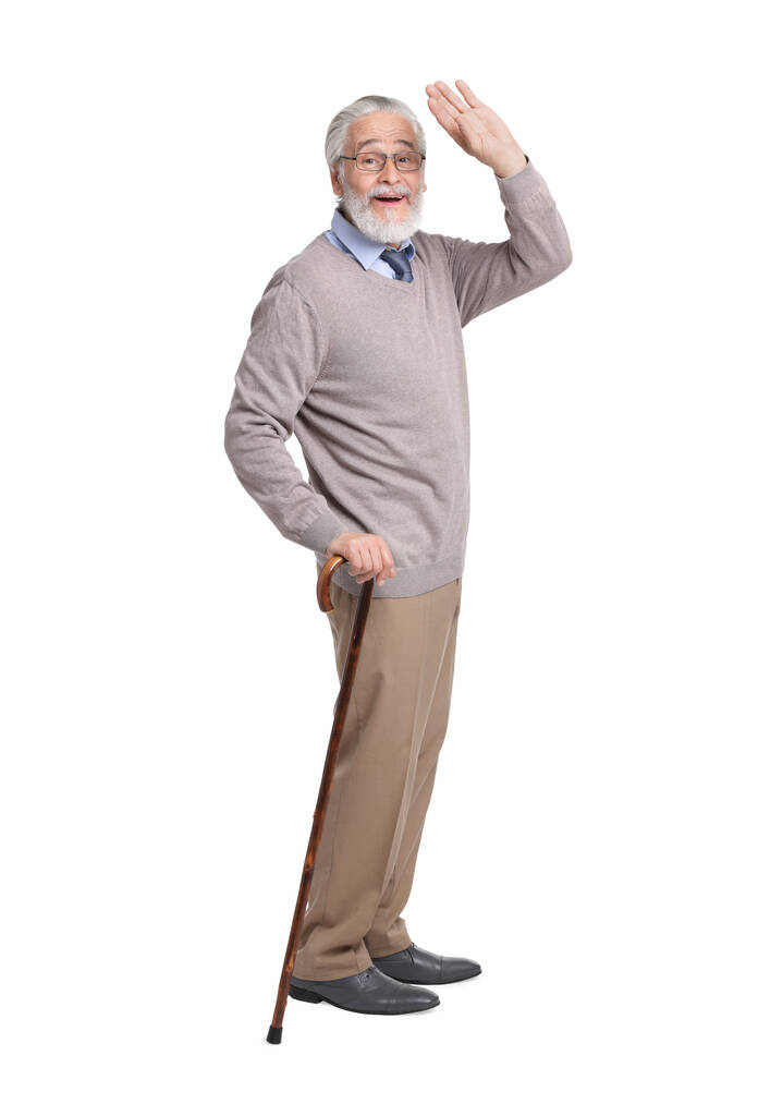 Senior man met wandelstok op witte achtergrond - Foto, afbeelding