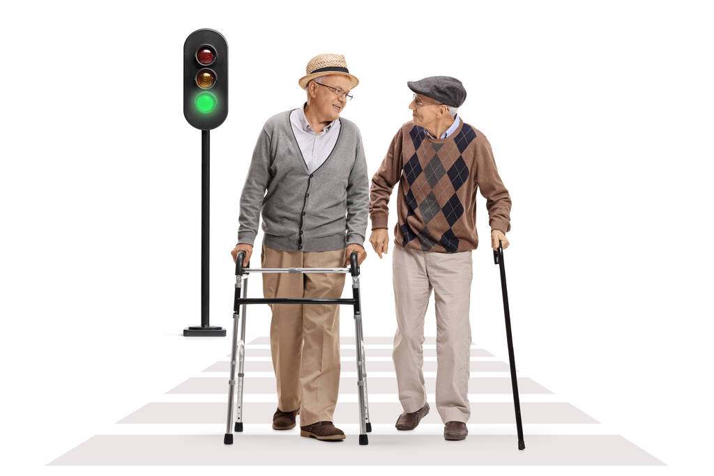 Full length portrait of an elderly men crossing a street and talking isolated on white background - Photo, Image