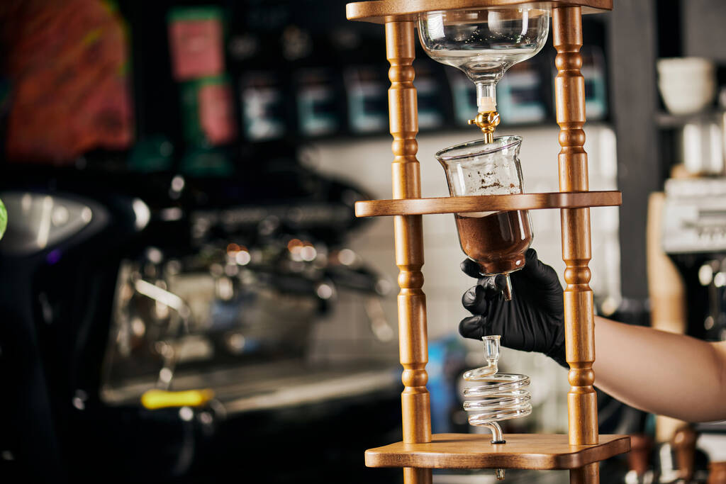 alternative Espressomaschine, Barista in schwarzem Handschuh zur Einstellung der kalten Tropfkaffeemaschine im Café - Foto, Bild