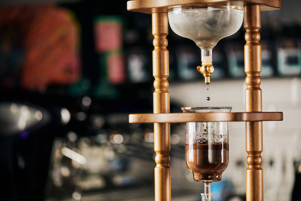 alternative way of espresso brewing, cold water dripping on ground coffee in cold brew coffee maker - Photo, Image