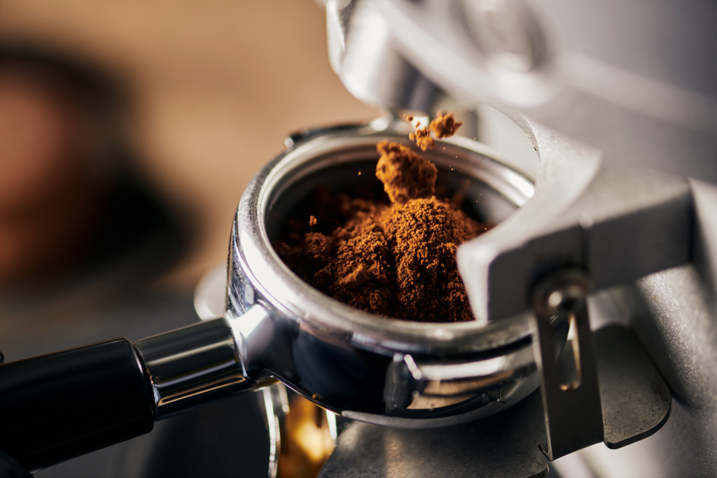 preparation of espresso, grinded coffee in portafilter, coffee machine, close up, coffee extraction  - Photo, Image