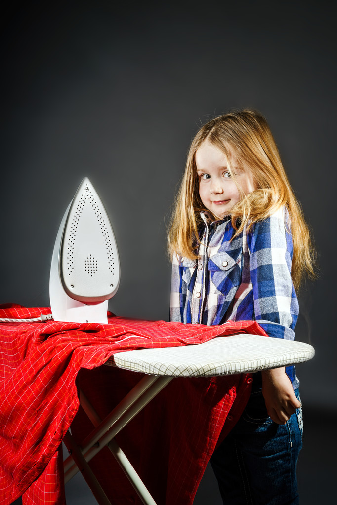 Cute little girl helping your mother by ironing clothes, contras - Photo, Image