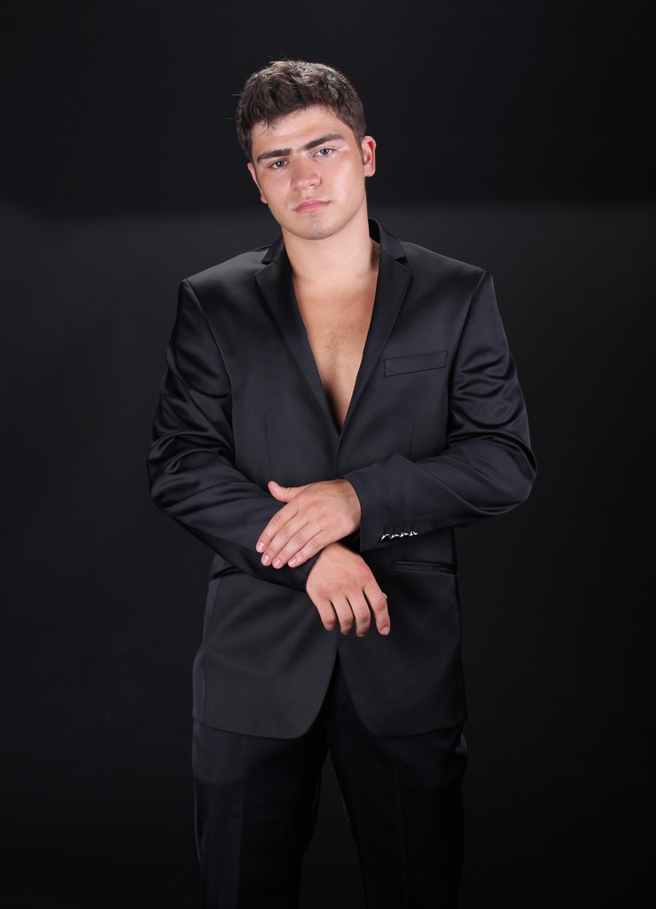 Bonito homem elegante em terno preto elegante isolado no bac escuro
 - Foto, Imagem