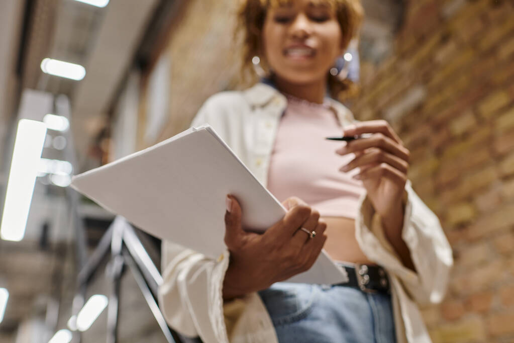 focus on papers, african american woman holding documents, blurred, coworking, startup, close up - Photo, Image
