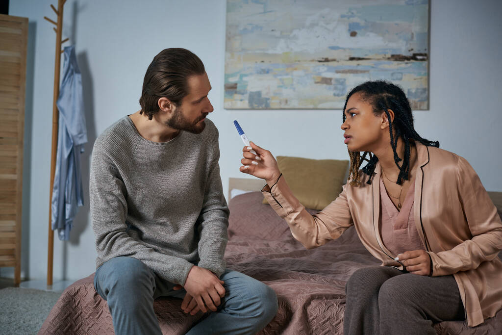 angry african american woman arguing with man, showing pregnancy test, blame, abortion concept - Photo, Image