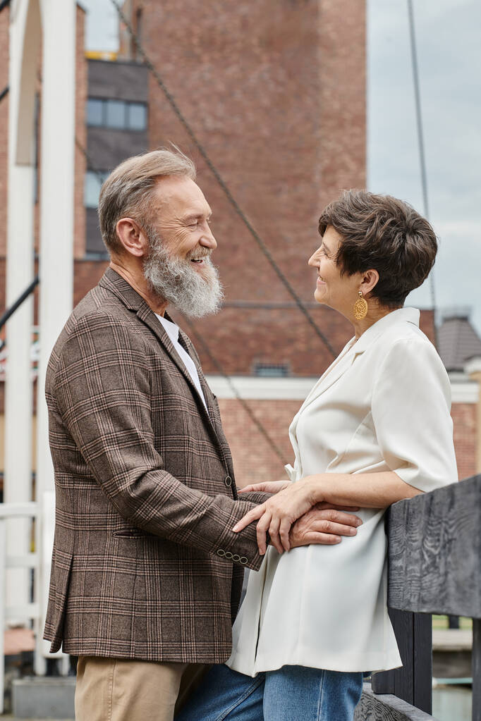 senior affection, cheerful bearded man looking at woman, elderly couple, husband and wife, romance - Photo, Image