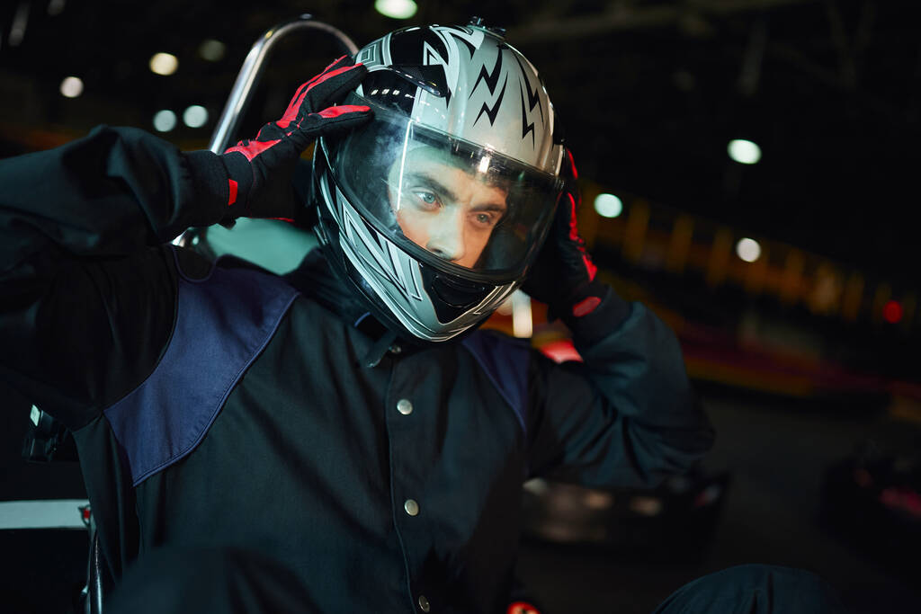 go kart driver taking off helmet after racing on circuit, speed drive and motorsport concept - Photo, Image