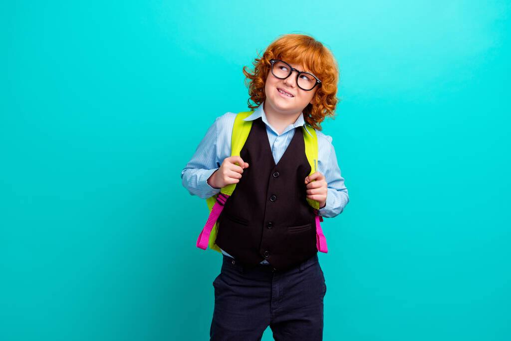 Portrait of minded small schoolkid hold backpack look interested empty space brainstorming isolated on cyan color background. - Photo, Image