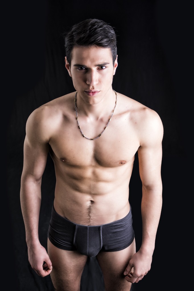 Handsome, fit young man in underwear isolated on black - Photo, Image
