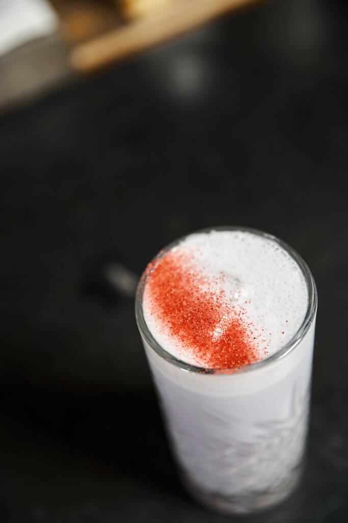 high angle view of glass with delicious milk punch flavored with cinnamon, cocktail presentation - Photo, Image