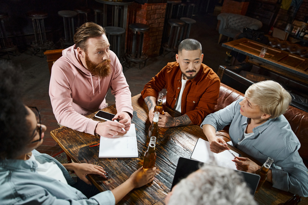 equipe criativa de amigos de trabalho multiétnico planejando novo projeto de negócios enquanto sentado no pub - Foto, Imagem