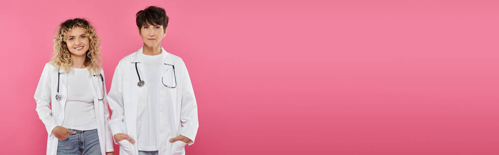 happy doctors in white coats standing on pink backdrop, women, joy, breast cancer awareness, banner - Photo, Image