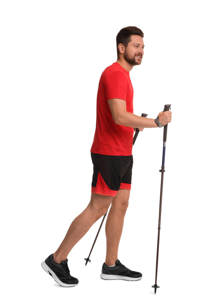 Man practicing Nordic walking with poles isolated on white - Photo, Image