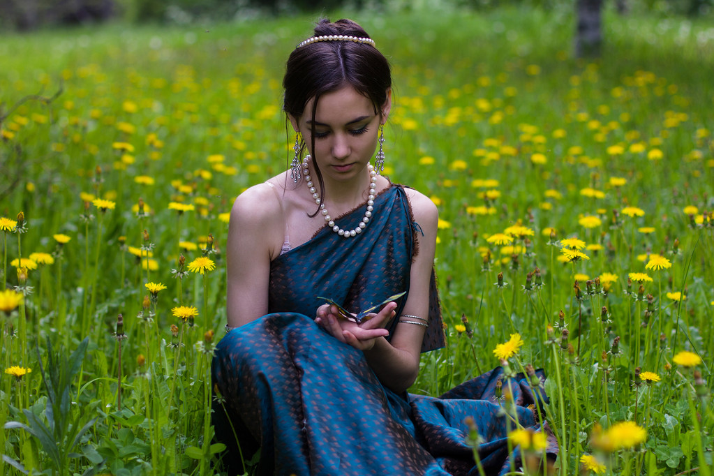 the girl in the dandelions holding a butterfly - Photo, Image