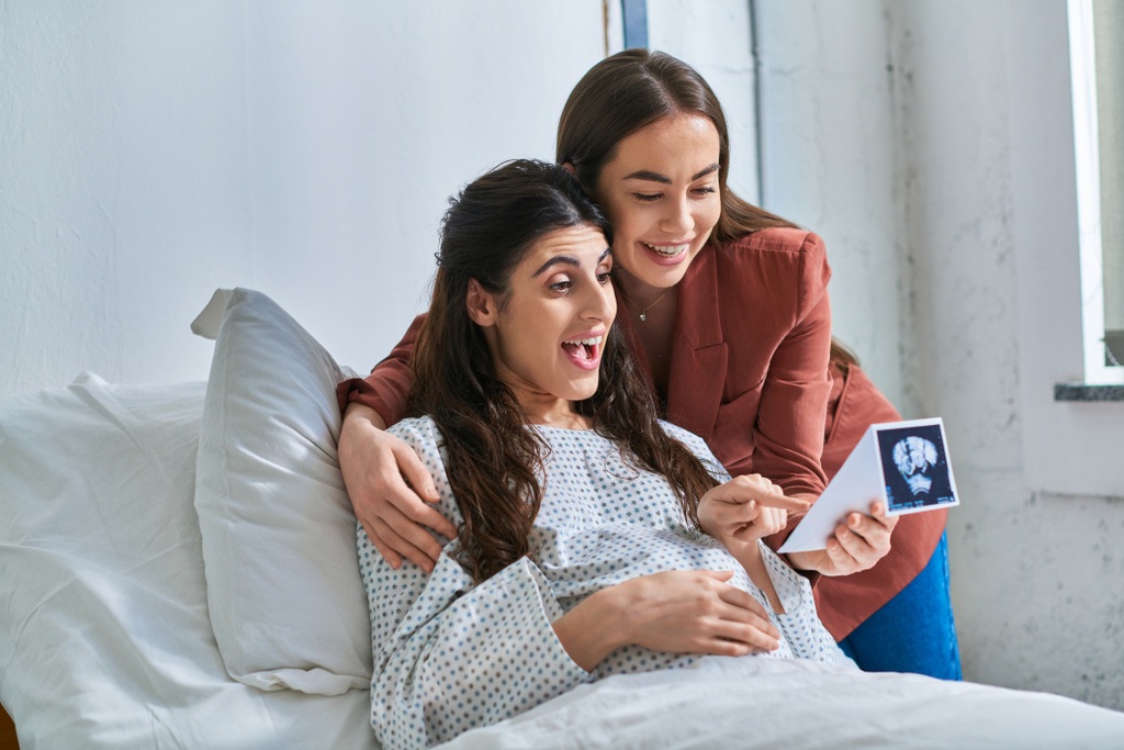 sorprendido alegre lgbt pareja mirando ultrasonido de su bebé con las manos en el vientre, ivf concepto - Foto, imagen