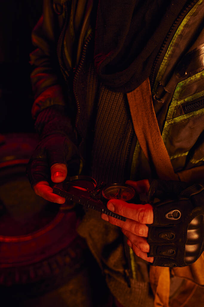 cropped view of man in fingerless gloves holding pressure gauge of abandoned subway carriage - Photo, Image