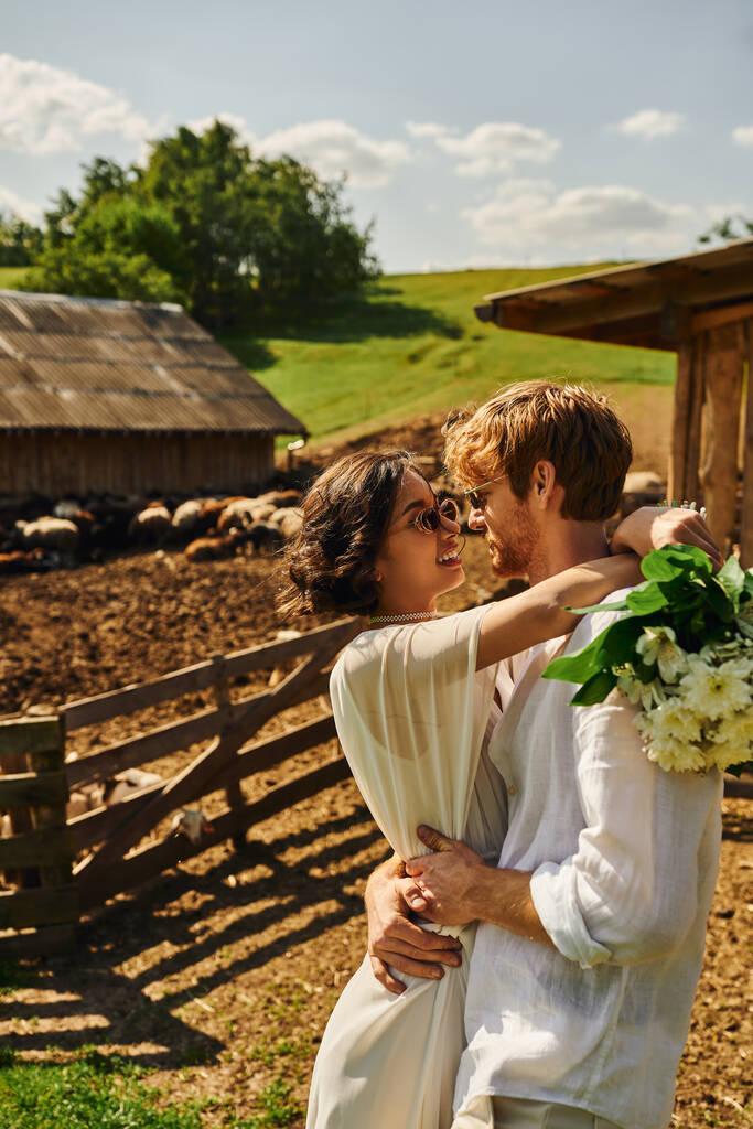 rustic wedding in style of boho style, asian bride in wedding dress looking at groom in countryside - Photo, Image