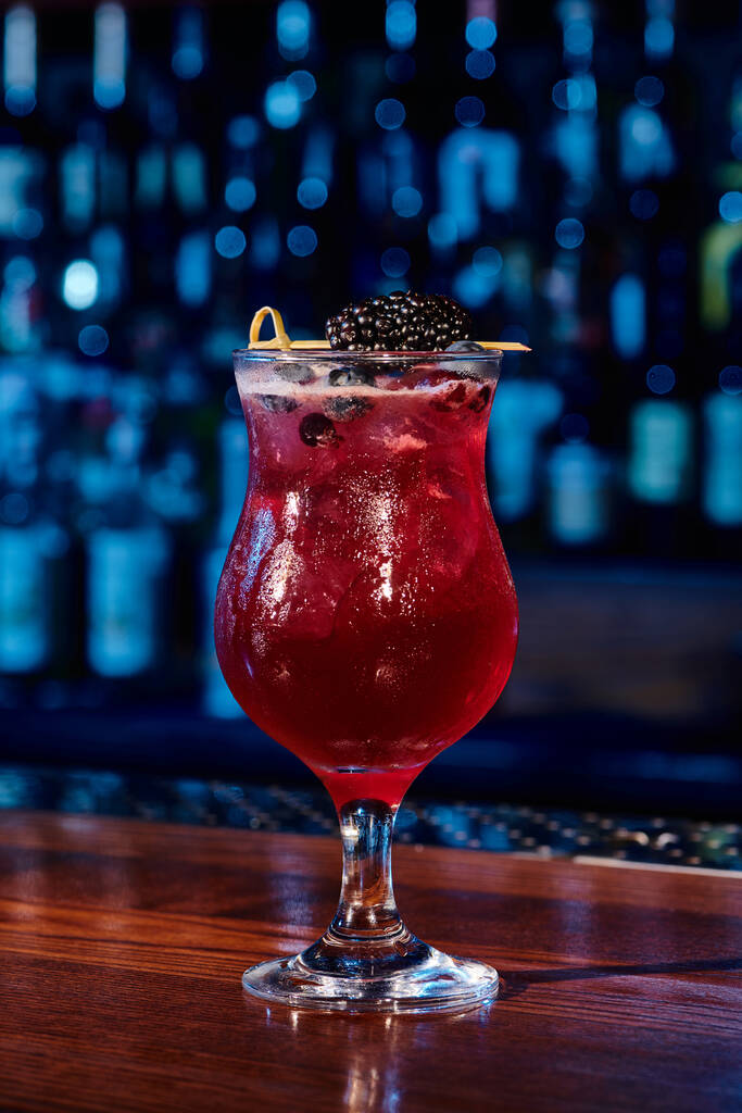 освежающий стакан ягодного блюза коктейль с ягодным декором на фоне бара, концепция - Фото, изображение
