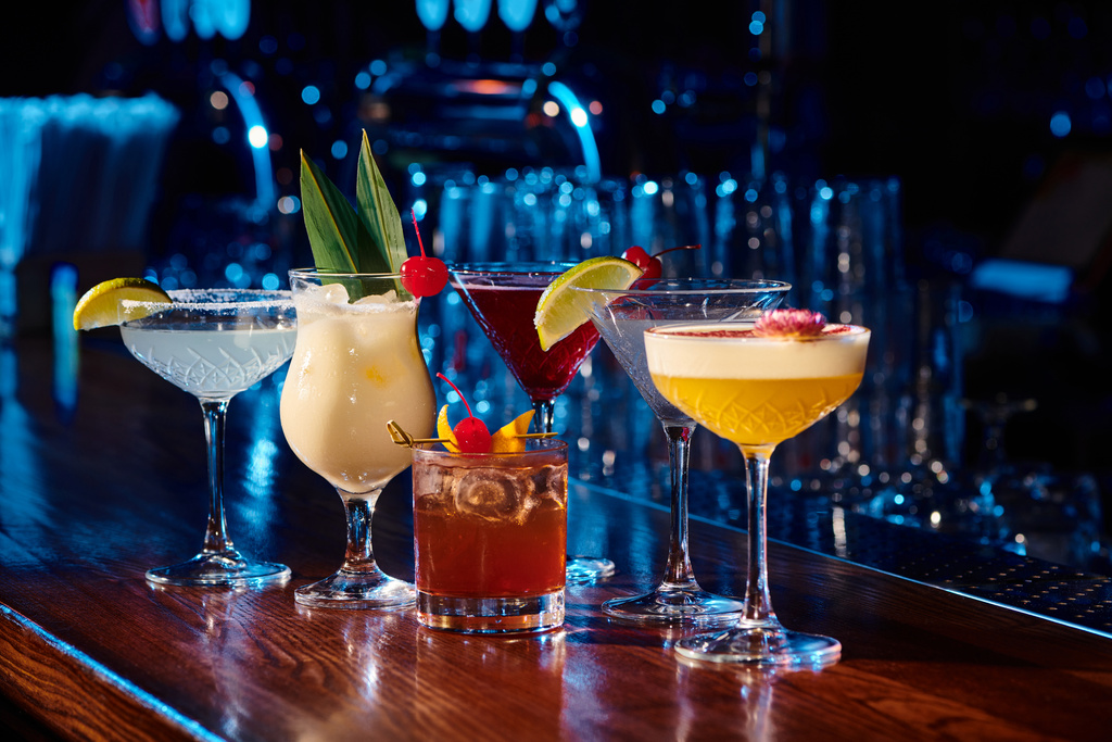 six different topical and elegant cocktails with bar cabinet on background, concept - Photo, Image