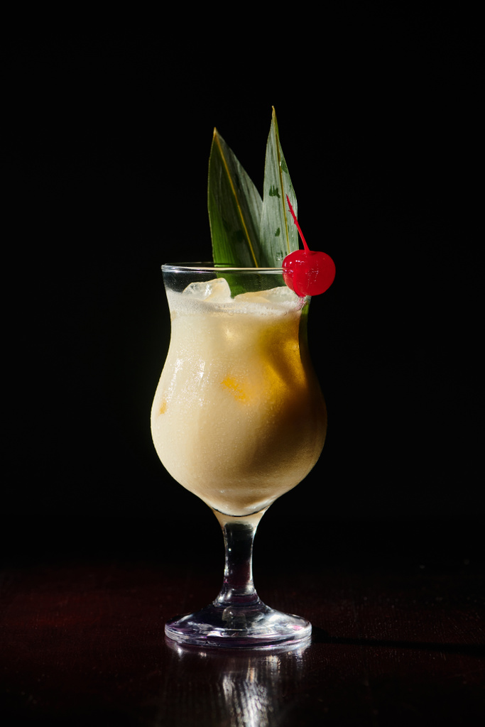 elegant pina colada with cocktail cherry on black background, object photo, concept - Photo, Image
