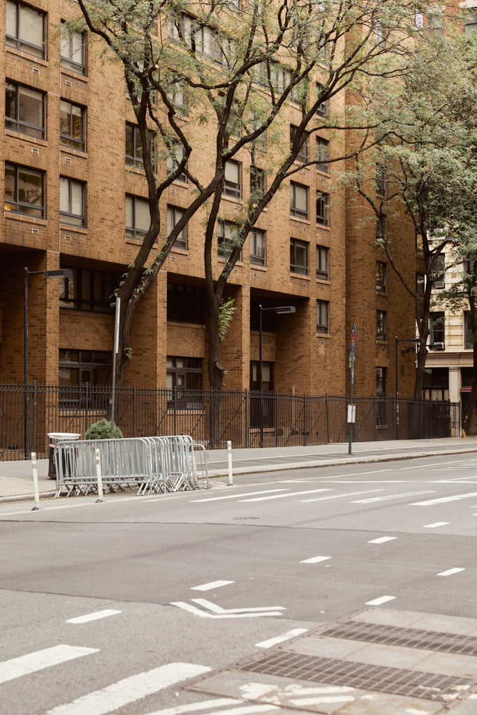 leveä tie lähellä tiilirakennusta ja syksyn puita New Yorkissa, metropolis streetscape - Valokuva, kuva
