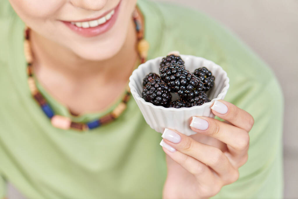 cropped view of joyful woman with bowl of ripe blackberries, delicious vegetarian diet concept - Photo, Image