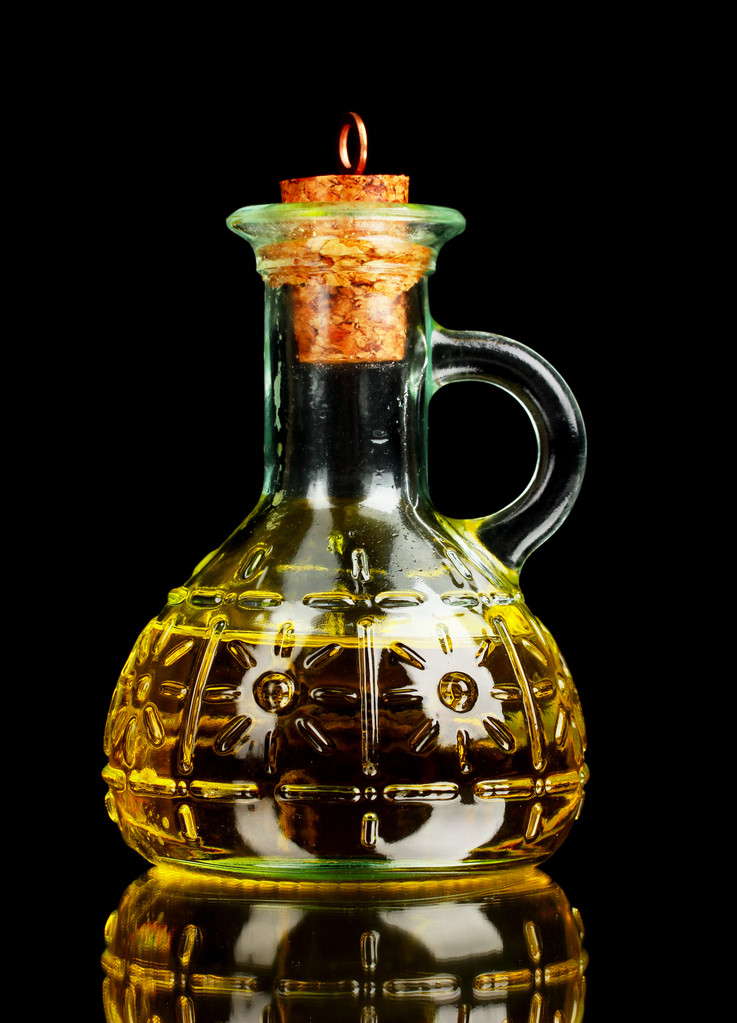 Jar with olive oil on a gray background - Photo, Image
