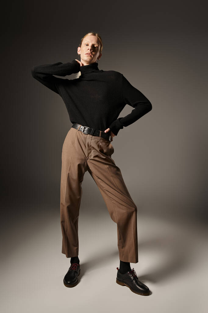 vertical shot of young non binary person in black turtleneck posing and looking at camera, fashion - Photo, Image