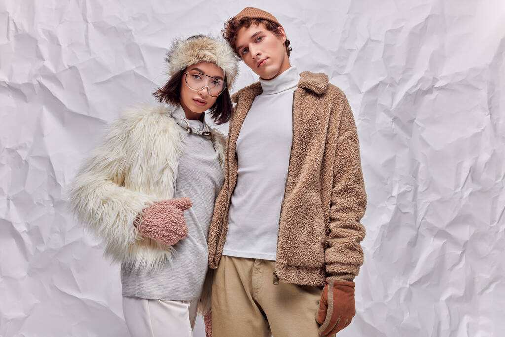 fashion lookbook concept, interracial models in winter attire posing on white textured background - Photo, Image