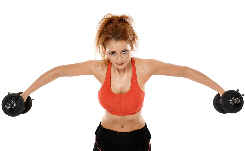 Joven mujer en forma haciendo ejercicio con pesas
 - Foto, Imagen