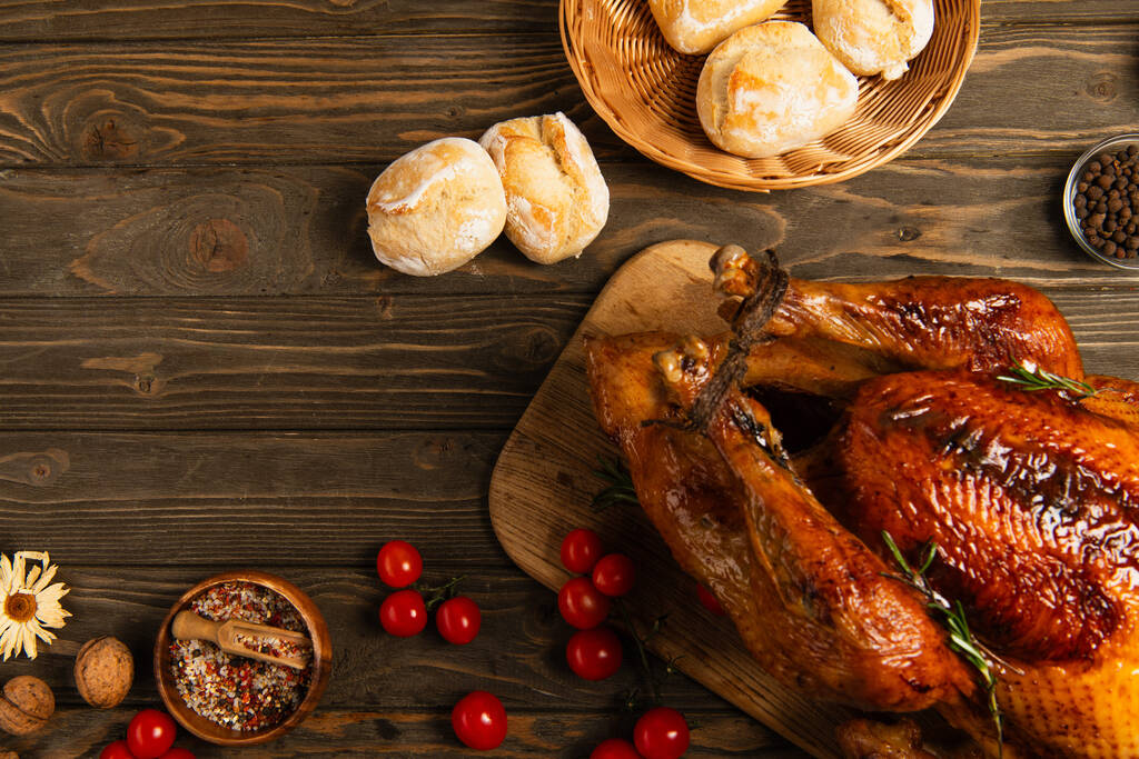 スパイスやチェリートマトの近くで焼いた七面鳥とパン,おいしい感謝祭 - 写真・画像