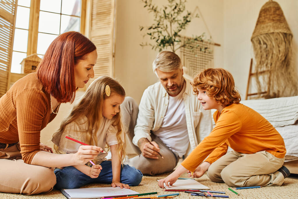 excited children drawing together with parents on floor in cozy living room, creative activities - Photo, Image