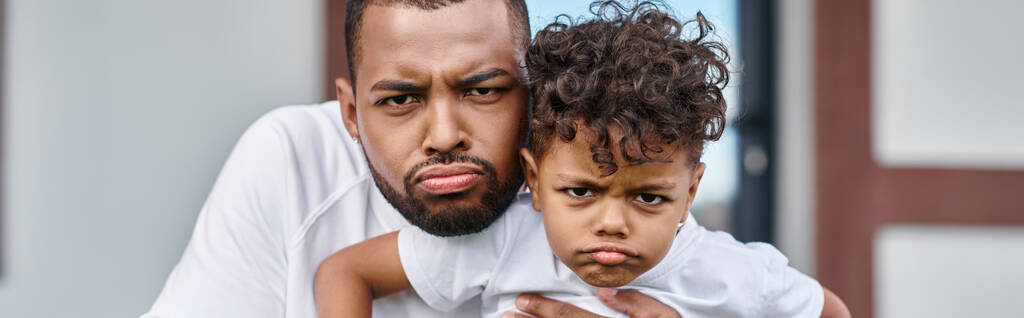 funny portrait of african american son and father looking displeased and looking at camera, banner - Photo, Image