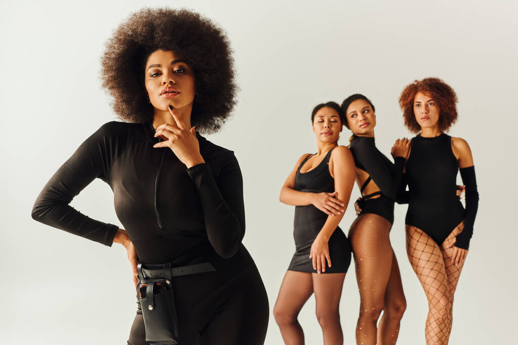 appealing sexy african american women in black stylish bodysuits posing together, fashion concept - Photo, Image