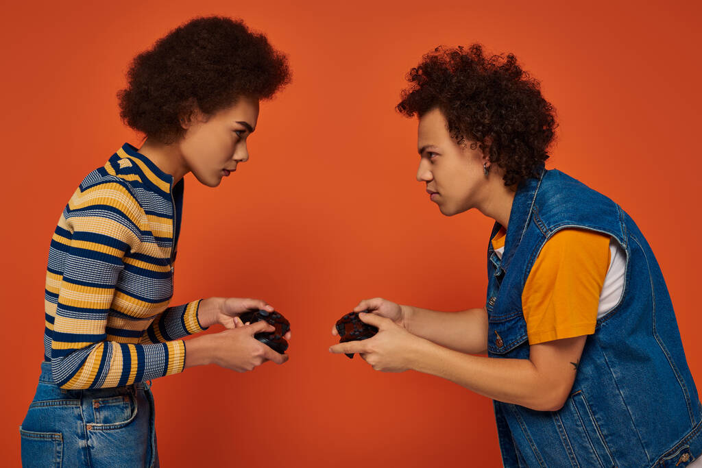 stylische afrikanisch-amerikanische Bruder und Schwester, die Videospiele mit Joystick spielen, Familienkonzept - Foto, Bild