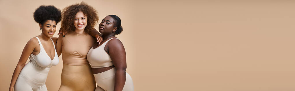 multiethnic body positive women in underwear smiling on beige backdrop, plus size beauty, banner - Photo, Image