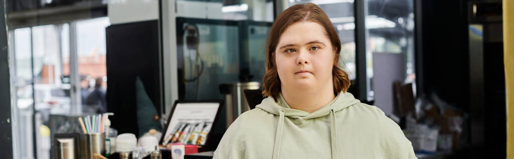 young woman with down syndrome looking at camera while working in modern cafe, horizontal banner - Photo, Image