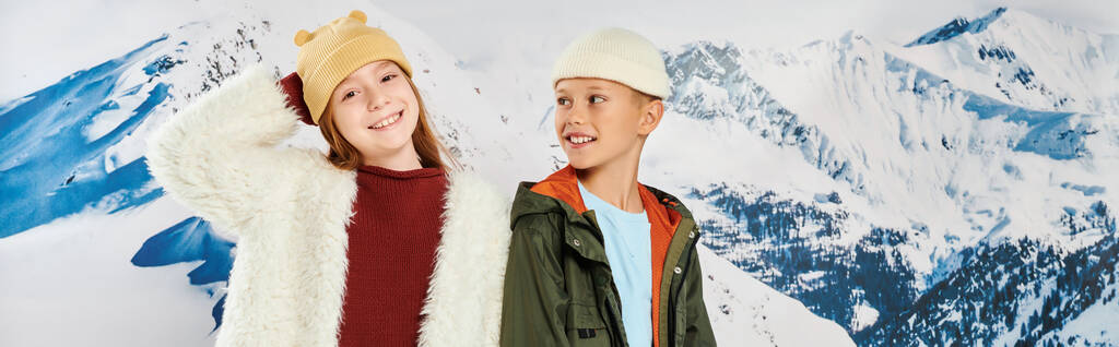 little boy looking at cute girl, both in winter stylish outfits smiling happily, fashion, banner - Photo, Image