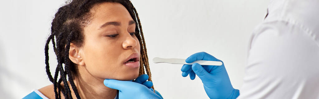 jong ziek Afrikaans amerikaans vrouw in ziekenhuis afdeling met arts check up van keel, gezondheidszorg - Foto, afbeelding