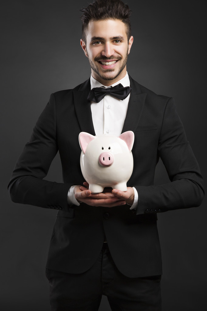 Rich man holding a pig box - Photo, Image