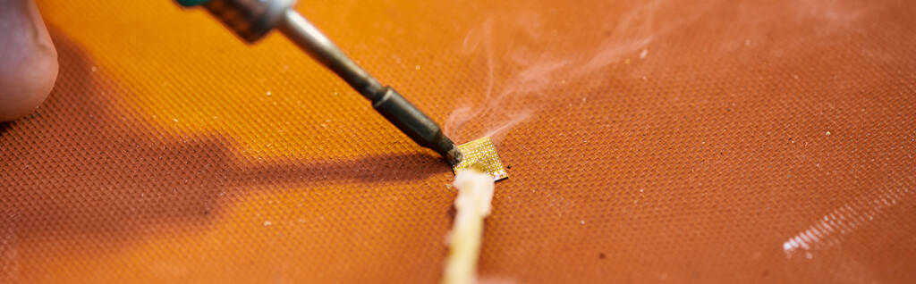 cropped view of professional technician soldering chipset of electronic gadget in workshop, banner - Photo, Image