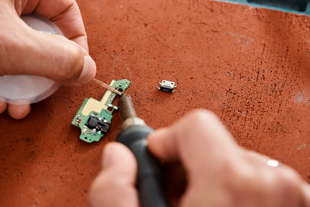 cropped view of skilled technician soldering electronic microscheme in workshop, small business - Photo, Image
