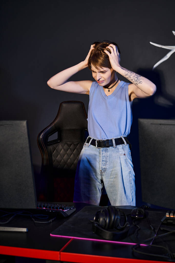 frustrated woman with tattoo on hand looking at computer and stressing out, defeated player - Photo, Image