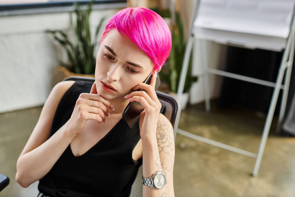 pensive young short haired female worker in casual attire talking by phone, business concept - Photo, Image