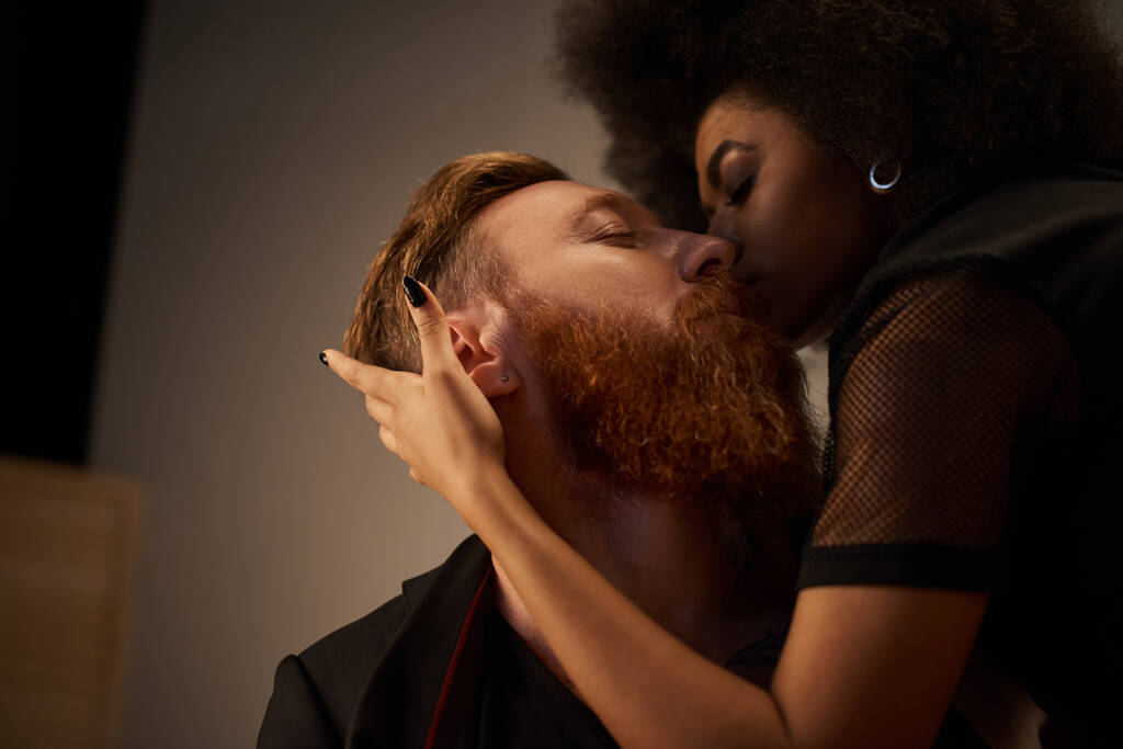 Romanttinen yö monipuolinen pari intiimissä ympäristössä, afrikkalainen amerikkalainen nainen suutelee tatuoitu mies - Valokuva, kuva