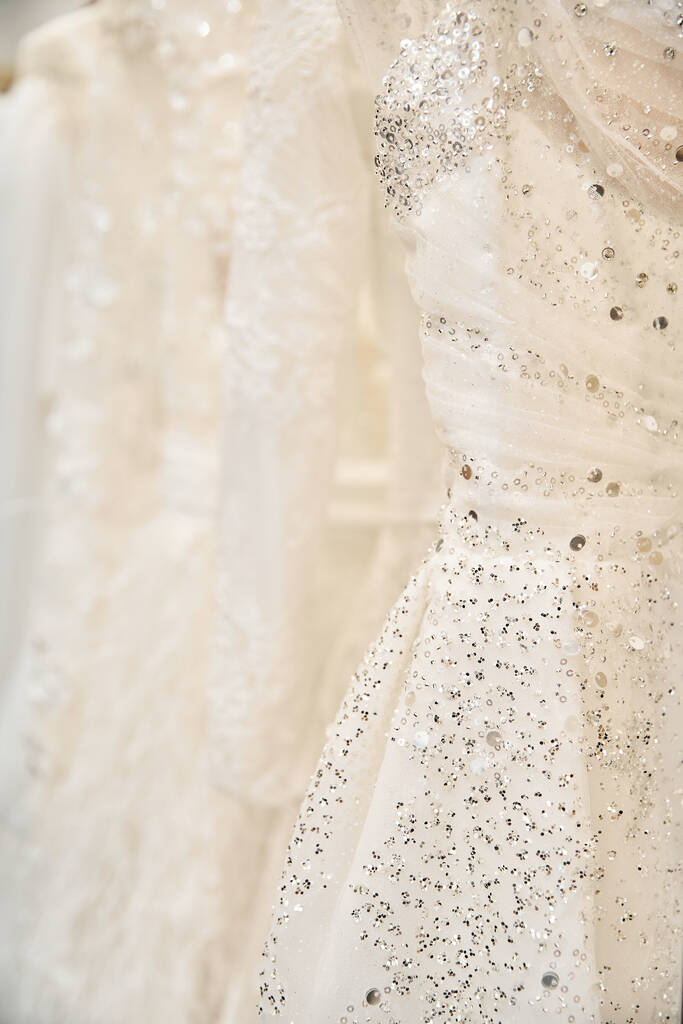 Un momento sereno en una tienda nupcial con un vestido de novia prístino colgado en un estante, esperando a una novia joven - Foto, Imagen
